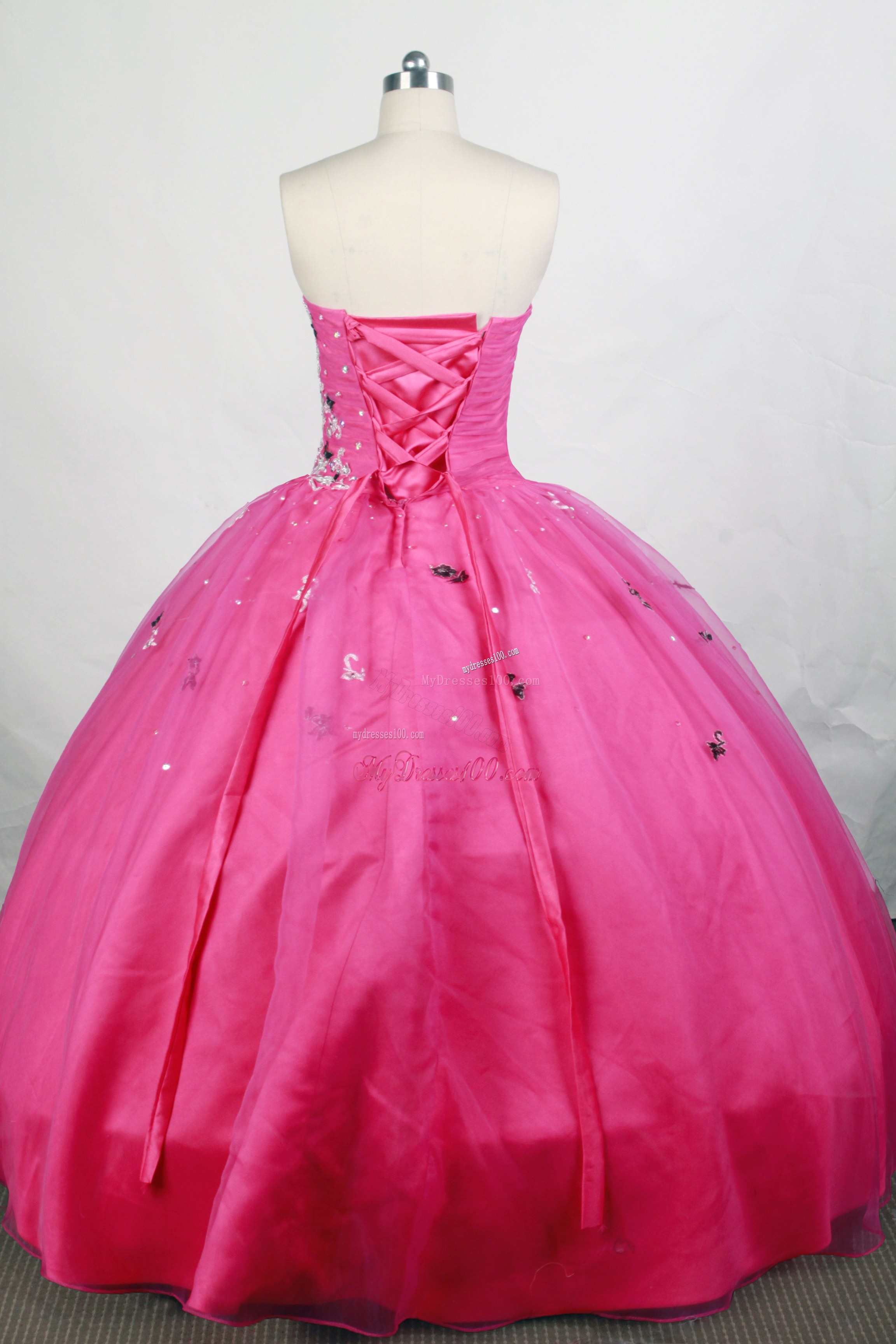 Black and White Appliques Decorate Quinceanera Gown in Hot Pink