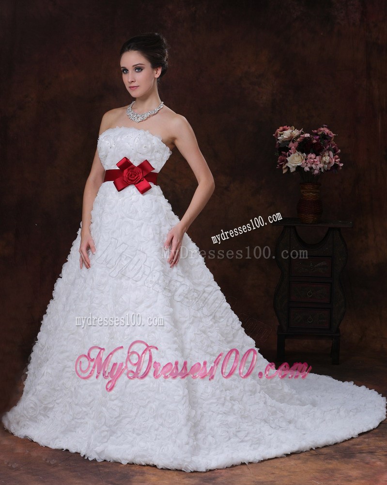 Brush Train Wedding Gown with Rolling Flowers over Skirt and Red Belt