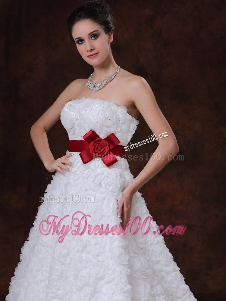 Brush Train Wedding Gown with Rolling Flowers over Skirt and Red Belt