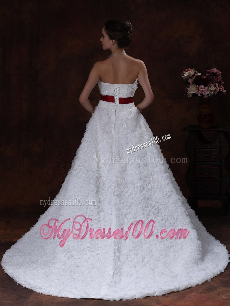 Brush Train Wedding Gown with Rolling Flowers over Skirt and Red Belt