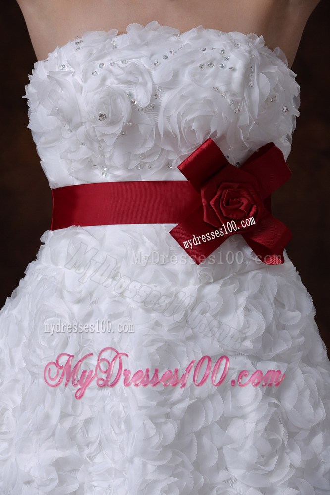 Brush Train Wedding Gown with Rolling Flowers over Skirt and Red Belt