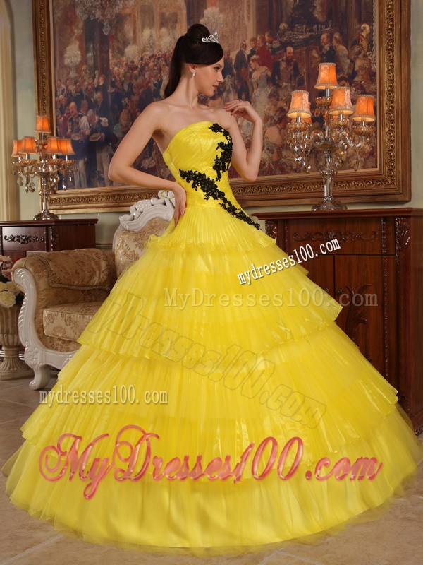 Shining Yellow Quinceanera Dress with Layers and Black Appliques