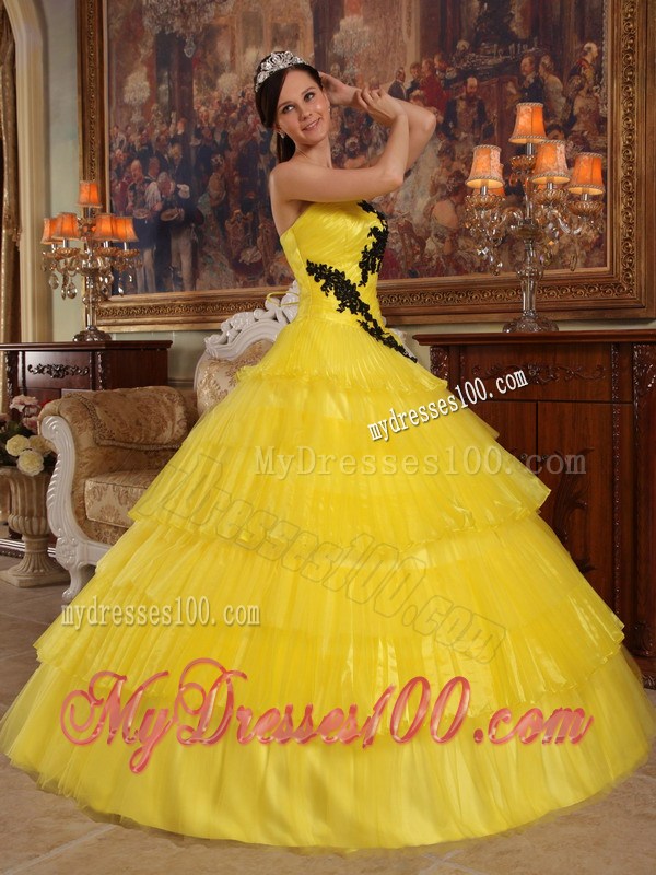 Shining Yellow Quinceanera Dress with Layers and Black Appliques